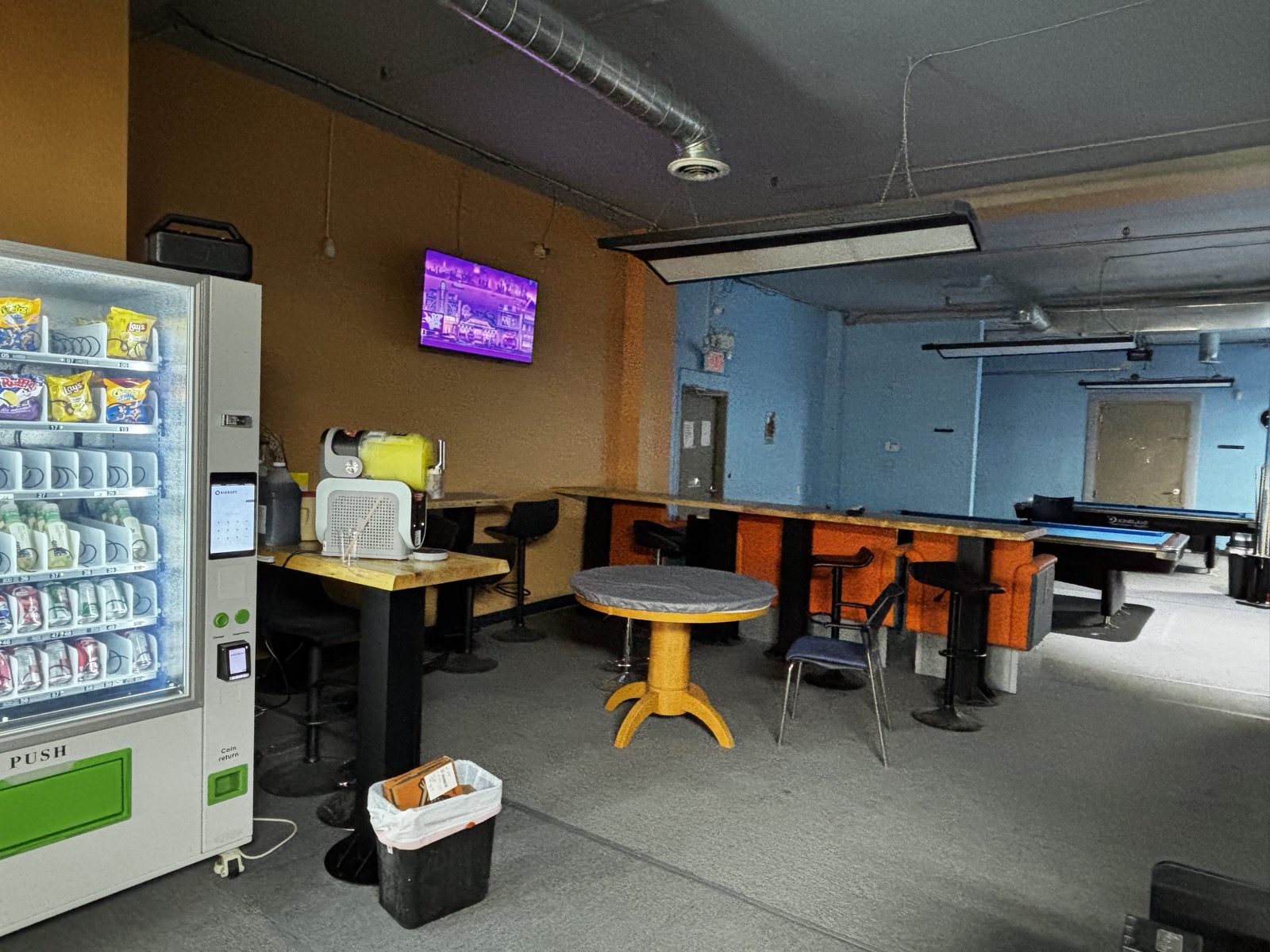 Slush machine, vending machine, lounge seating, and pool tables at 24Billiards.
